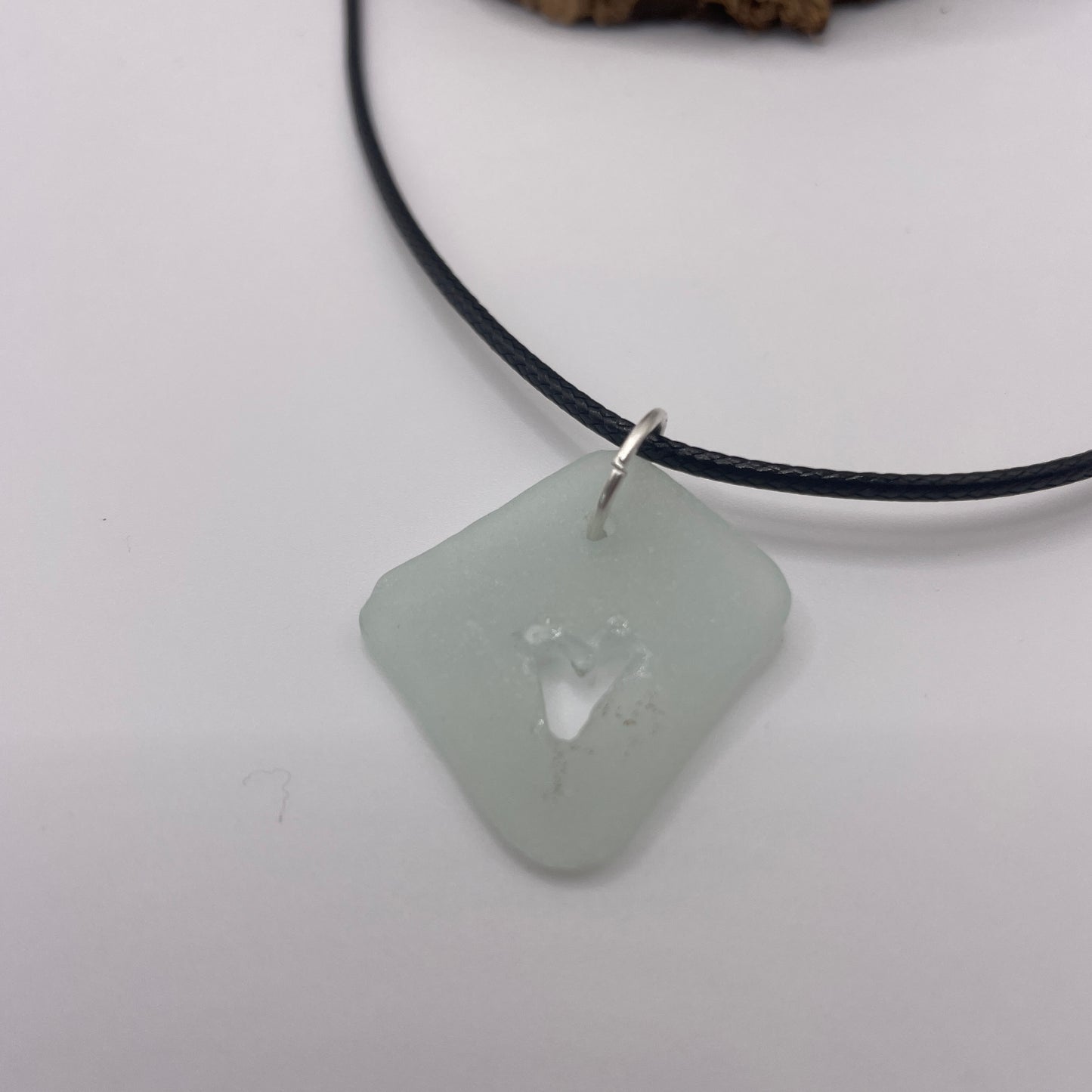 carved sea glass pendant